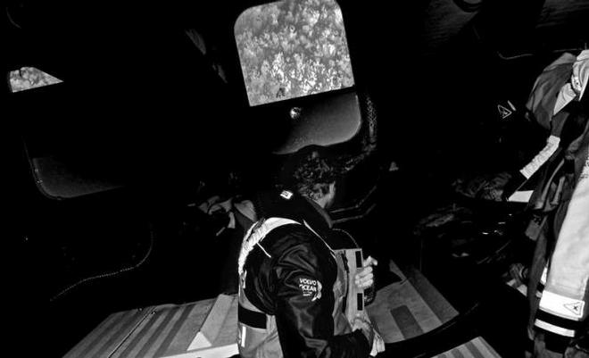 Onboard Team Brunel - Jens Dolmer sits below deck having just come off watch looking up at the water pouring over the hatch - Leg five to Itajai -  Volvo Ocean Race 2015 © Stefan Coppers/Team Brunel